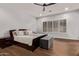 Spacious bedroom features a dark wood bed frame, hardwood floors, and a window with shutter blinds at 4667 E Reins Rd, Gilbert, AZ 85297