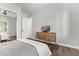 Bedroom with a bed, dresser, wood-look floors, and an open closet at 4667 E Reins Rd, Gilbert, AZ 85297