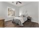 Neutral bedroom with a bed, two side tables, gray bedding, and a window with plantation shutters at 4667 E Reins Rd, Gilbert, AZ 85297