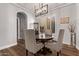 Charming dining room features a wood table, gray upholstered chairs, and modern light fixture at 4667 E Reins Rd, Gilbert, AZ 85297