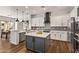 Bright kitchen features a central island, stainless appliances, white cabinets, and stylish pendant lighting at 4667 E Reins Rd, Gilbert, AZ 85297