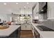Modern kitchen features white cabinets, quartz countertops, stainless steel appliances, and backyard views at 4667 E Reins Rd, Gilbert, AZ 85297