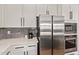 Modern kitchen featuring stainless steel appliances, white cabinets, and sleek countertops at 4667 E Reins Rd, Gilbert, AZ 85297