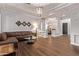 Open-concept living room showcasing wood floors, chandelier, and seamless flow into the dining area at 4667 E Reins Rd, Gilbert, AZ 85297