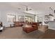 Bright and spacious living room with a leather sofa, recessed lighting, and shutters on the windows at 4667 E Reins Rd, Gilbert, AZ 85297