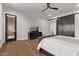 This main bedroom features hardwood floors, a ceiling fan, and a door to the outside at 4667 E Reins Rd, Gilbert, AZ 85297