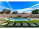 Stunning pool with decorative water features and lush landscaping creates a relaxing oasis at 4667 E Reins Rd, Gilbert, AZ 85297