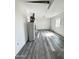 Unfinished basement featuring durable laminate floors, water heater, and white painted walls and a window at 4916 W Earll Dr, Phoenix, AZ 85031