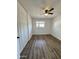 Bedroom featuring wood-look flooring, white brick walls, window with blinds, and a closet at 4916 W Earll Dr, Phoenix, AZ 85031