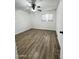 Bedroom featuring wood-look flooring, white brick walls, window with blinds, and a ceiling fan at 4916 W Earll Dr, Phoenix, AZ 85031
