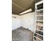 Room with pegboard walls and shelving units, providing ample storage and organization at 4916 W Earll Dr, Phoenix, AZ 85031