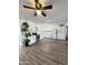 Bright kitchen featuring white cabinets, new stainless steel appliances, marble countertops, and modern wood-look flooring at 4916 W Earll Dr, Phoenix, AZ 85031