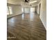 Bright open-concept living area with a neutral color palette, wood-look flooring, and lots of natural light at 4916 W Earll Dr, Phoenix, AZ 85031