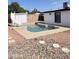 Backyard pool area with a white outbuilding and plenty of space for outdoor enjoyment at 4916 W Earll Dr, Phoenix, AZ 85031