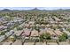 Expansive aerial view of a tranquil community with lush landscaping and stunning mountain views in the distance at 5303 W Hackamore Dr, Phoenix, AZ 85083