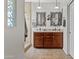 Bright bathroom featuring a double sink vanity, decorative mirrors, and a step-in shower at 5303 W Hackamore Dr, Phoenix, AZ 85083