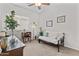 Comfortable bedroom with a small seating area, desk, carpet flooring and natural light at 5303 W Hackamore Dr, Phoenix, AZ 85083