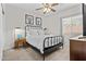 Bright bedroom with a metal bed frame, carpet flooring, natural light, and decorative pictures on the wall at 5303 W Hackamore Dr, Phoenix, AZ 85083