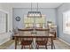 Dining room featuring a wooden table with chairs, a modern chandelier, and natural light at 5303 W Hackamore Dr, Phoenix, AZ 85083