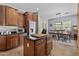 Eat-in kitchen featuring wood cabinets, granite counters, and a stainless steel refrigerator at 5303 W Hackamore Dr, Phoenix, AZ 85083