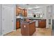 Charming kitchen with wood cabinets, granite counters, and a functional kitchen island at 5303 W Hackamore Dr, Phoenix, AZ 85083