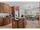 Functional kitchen with wood cabinets, stainless steel appliances, black countertops and center island at 5303 W Hackamore Dr, Phoenix, AZ 85083
