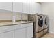 Convenient laundry room equipped with a sink and modern washer and dryer at 5303 W Hackamore Dr, Phoenix, AZ 85083