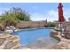 Backyard pool with a waterfall feature and desert landscaping at 5303 W Hackamore Dr, Phoenix, AZ 85083