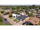 An aerial view captures the neighborhood, highlighting the home's position with a dark roof and mature trees at 5808 W Myrtle Ave, Glendale, AZ 85301