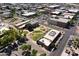 Aerial view of a well-kept grassy area with trees near buildings with parking, providing a neighborhood perspective at 5808 W Myrtle Ave, Glendale, AZ 85301