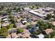 From above, the community shows tree-lined streets surrounding the home with a dark roof at 5808 W Myrtle Ave, Glendale, AZ 85301