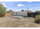 Backyard view features white exterior of home with a cement patio and newly constructed wooden fence at 5808 W Myrtle Ave, Glendale, AZ 85301
