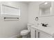 Well-lit bathroom featuring a new toilet, vanity, sink, and modern fixtures at 5808 W Myrtle Ave, Glendale, AZ 85301
