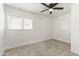 Bedroom with neutral carpet, white walls, ceiling fan and a bright window at 5808 W Myrtle Ave, Glendale, AZ 85301