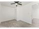 Bedroom with carpet, ceiling fan, white walls, trim and a walk-in closet at 5808 W Myrtle Ave, Glendale, AZ 85301