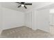 Bright carpeted bedroom with white walls, a ceiling fan, and a closet with bi-fold doors at 5808 W Myrtle Ave, Glendale, AZ 85301