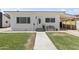 Charming single-story home featuring a well-kept lawn, walkway, covered parking, and decorative front door at 5808 W Myrtle Ave, Glendale, AZ 85301