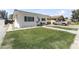 Charming white home showcasing a lush green lawn, walkway, and a gray pickup truck parked in the driveway at 5808 W Myrtle Ave, Glendale, AZ 85301