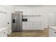 Stainless steel refrigerator and microwave with cabinets, countertops, and open pantry at 5808 W Myrtle Ave, Glendale, AZ 85301
