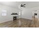 Cozy living room with a decorative fireplace, ceiling fan, and wood-look floors at 5808 W Myrtle Ave, Glendale, AZ 85301