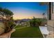 Tranquil backyard with lush artificial grass, modern fence and landscaping providing a serene outdoor space at 5905 N Echo Canyon Ln, Phoenix, AZ 85018