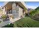 Lush backyard showcasing a well-manicured lawn, modern architecture, mature trees, and rock features at 5905 N Echo Canyon Ln, Phoenix, AZ 85018