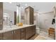 Modern bathroom with double vanity, granite countertops, and a glass-enclosed shower at 5905 N Echo Canyon Ln, Phoenix, AZ 85018
