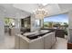 Open concept dining area with a large chandelier, adjacent to the kitchen with an eat-in breakfast bar at 5905 N Echo Canyon Ln, Phoenix, AZ 85018