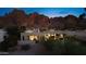 Contemporary home with large windows offering views, complemented by desert landscaping, set against a majestic mountain at 5905 N Echo Canyon Ln, Phoenix, AZ 85018