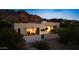Modern home featuring large windows and desert landscaping, providing captivating mountain views and a serene setting at 5905 N Echo Canyon Ln, Phoenix, AZ 85018