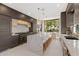 Gourmet kitchen featuring a marble island with seating and stainless steel appliances, and dark wood cabinets at 5905 N Echo Canyon Ln, Phoenix, AZ 85018