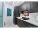 Modern laundry room featuring stylish gray cabinets, a marble countertop, stainless appliances, and elegant chandelier at 5905 N Echo Canyon Ln, Phoenix, AZ 85018