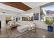 Bright, open-plan living room with stylish décor, a large white sectional and stunning mountain views at 5905 N Echo Canyon Ln, Phoenix, AZ 85018