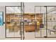 Spacious office features a wall of books, built-in shelving, and a modern glass partition at 5905 N Echo Canyon Ln, Phoenix, AZ 85018